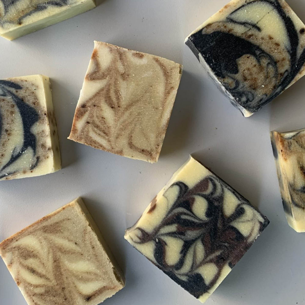 Swirl-patterned soap bars on a white surface
