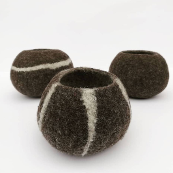Three brown felted bowls with white stripes on a white background