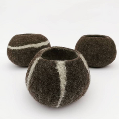 Three brown felted bowls with white stripes on a white background