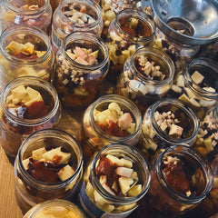 Jars filled with various ingredients on a wooden surface