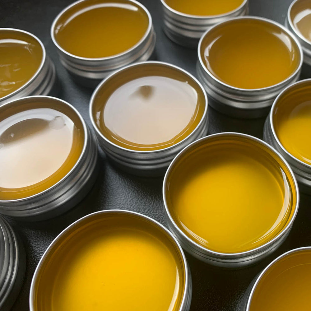 Multiple containers with yellow and white substances on a dark surface