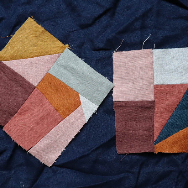 Color swatches of fabric in various colors on a dark blue fabric background