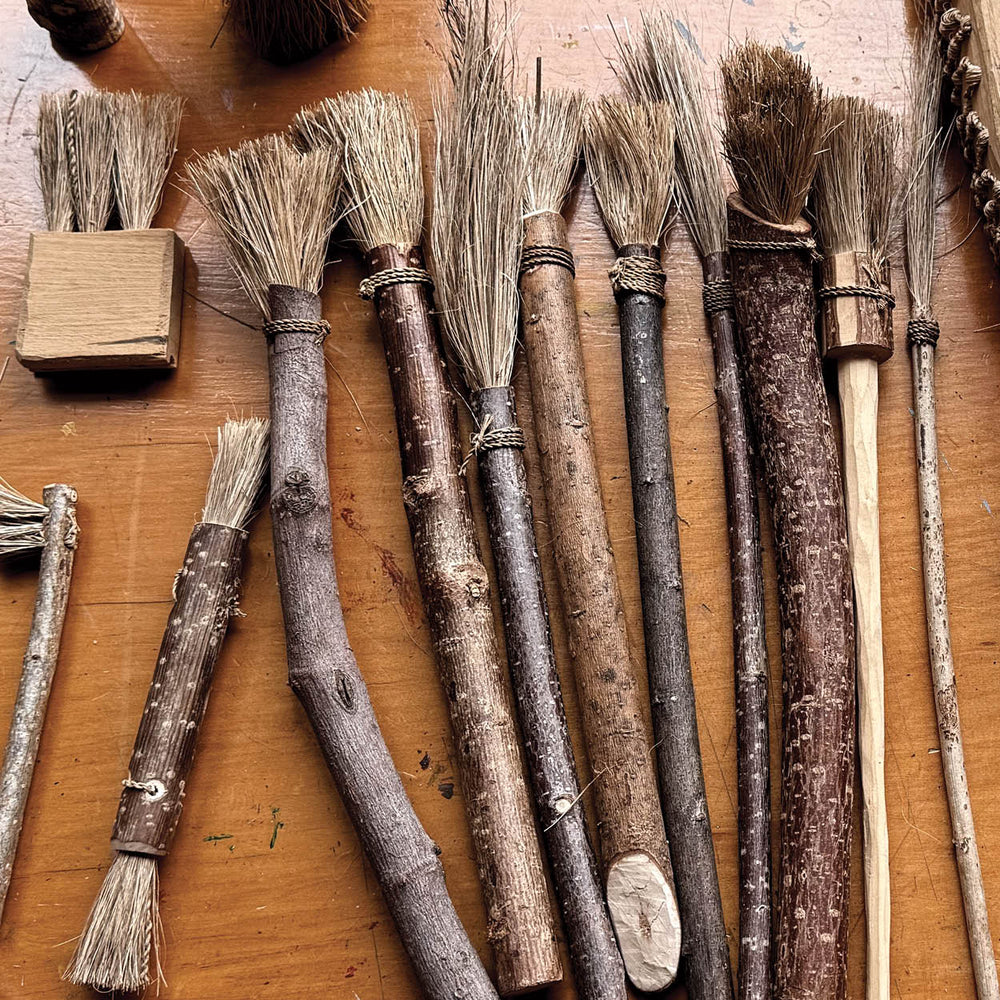 Set of rustic brushes on a wooden surface