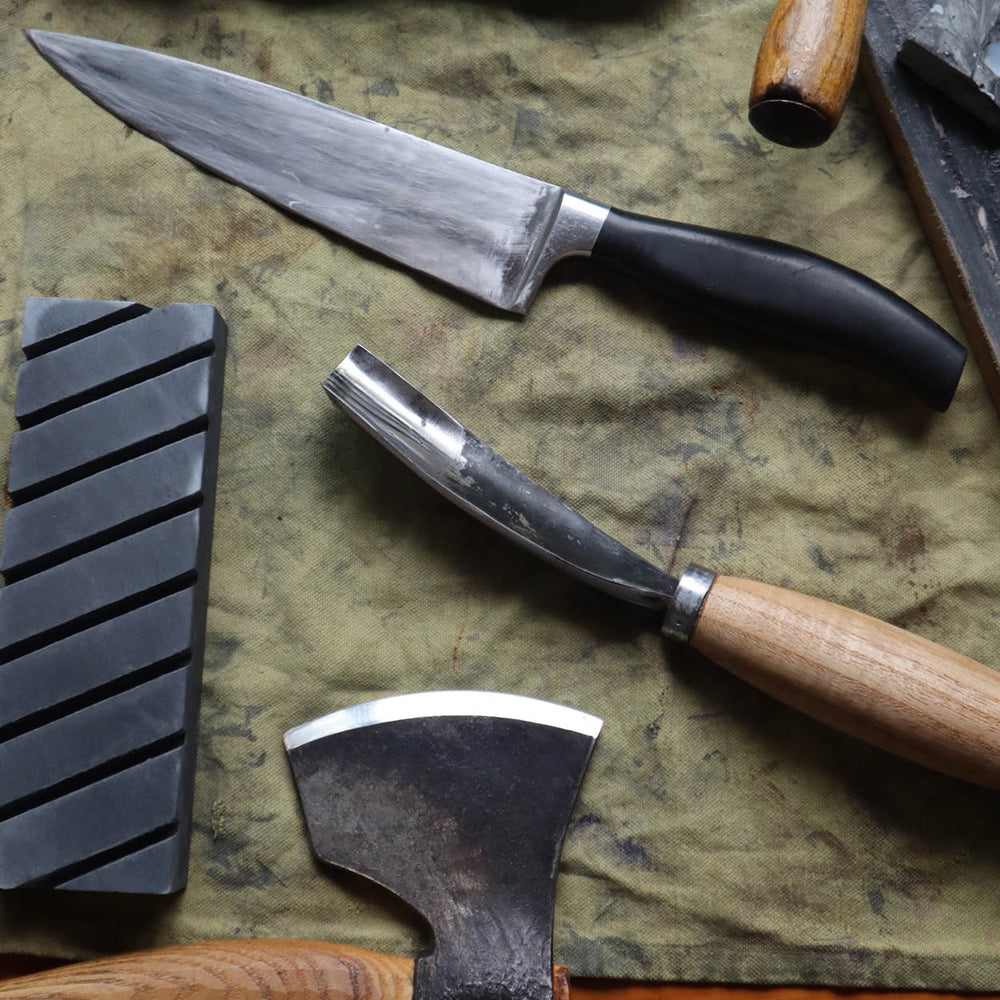 Set of knives and tools on a textured surface