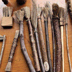 Set of rustic brushes on a wooden surface