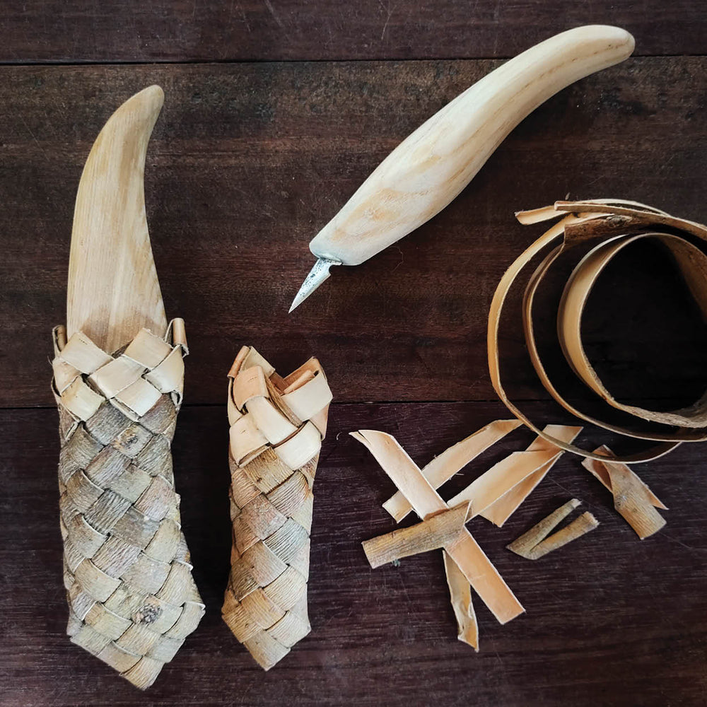 Wooden tool in a willow bark pouch on a wooden surface